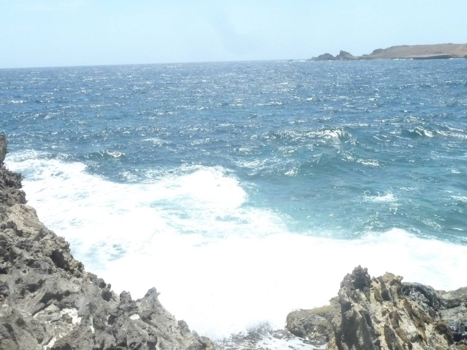 Waves breaking over volcanic rock on the windward coast