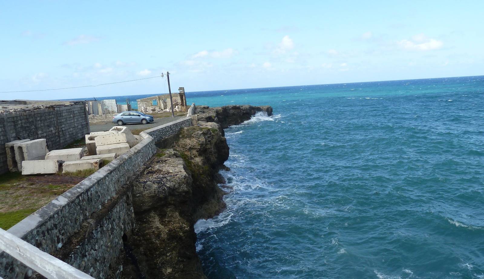 Waves breaking against limestone cliffs on the Jamaican coast