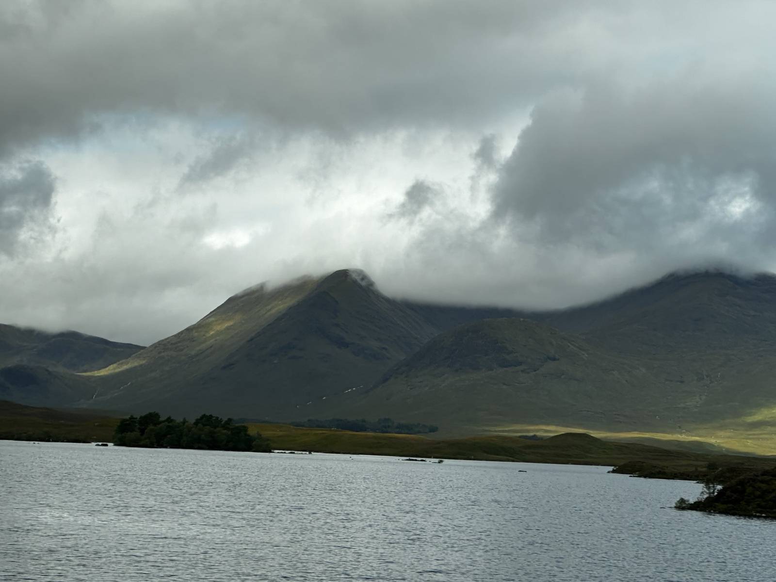 Storm clouds over a mountain and loch in the Scottish Highlands