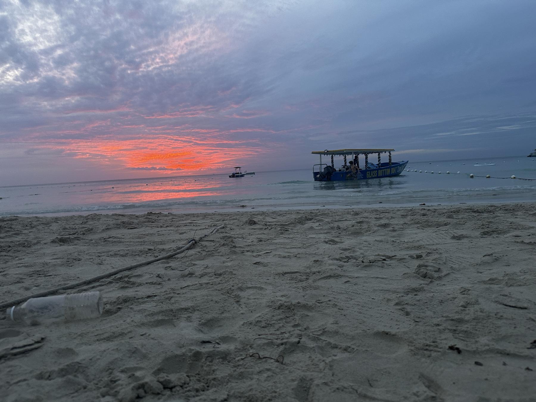 A blazing red sunset over the sea in Jamaica