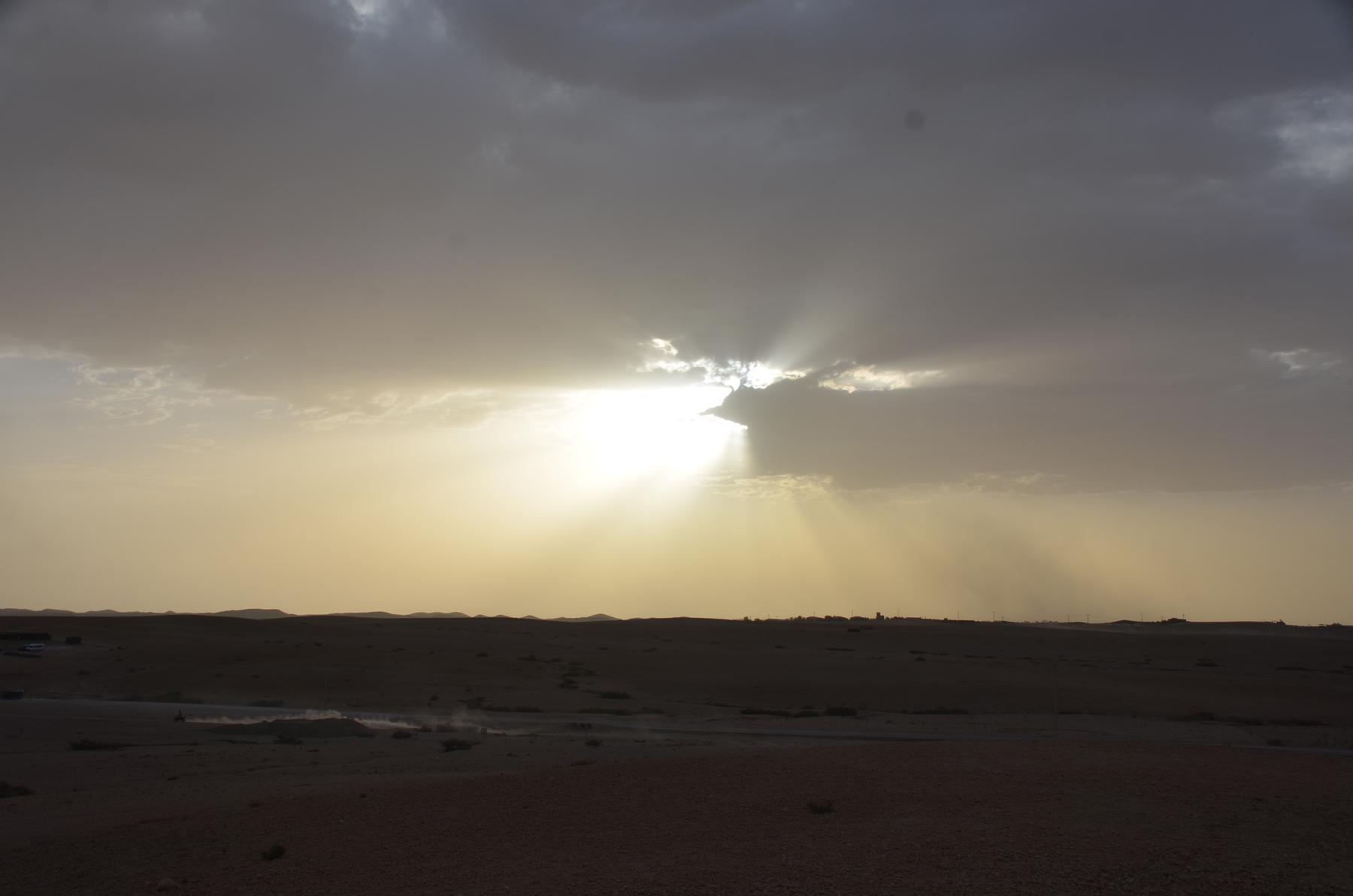 Sun breaking through clouds over the desert outside Marrakech